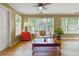 Bright living room featuring a ceiling fan, beige couch, and lots of natural light from the window at 3171 Davis Rd, Marietta, GA 30062