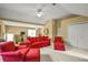 An upper level living area with red furniture and ample lighting from the windows at 3171 Davis Rd, Marietta, GA 30062