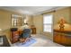 Home office with traditional wood desk, ample natural light, and neutral carpet at 3171 Davis Rd, Marietta, GA 30062