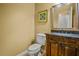 Well-lit powder room showcases a granite countertop and a stylish wooden vanity at 3171 Davis Rd, Marietta, GA 30062