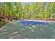 Well-maintained community tennis court for recreational use, surrounded by mature trees and secure fencing at 3171 Davis Rd, Marietta, GA 30062