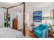 Bright main bedroom features a four-poster bed, wood floors, white walls, and a sitting chair at 318 Tuxworth Cir, Decatur, GA 30033