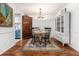 Bright dining room featuring hardwood floors, chandelier, and decorative rug at 318 Tuxworth Cir, Decatur, GA 30033