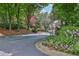 Community entrance lined with bright flowerbeds and a view of the community gate at 318 Tuxworth Cir, Decatur, GA 30033