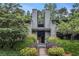 Charming two-story home with lush landscaping, mature trees, and inviting entrance at 318 Tuxworth Cir, Decatur, GA 30033