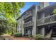 Multi-story building exterior with private balconies, stairs, and mature trees at 318 Tuxworth Cir, Decatur, GA 30033
