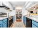 Galley kitchen featuring stainless steel appliances, white and blue cabinets, and updated countertops at 318 Tuxworth Cir, Decatur, GA 30033