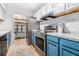 Galley kitchen featuring stainless steel appliances, white and blue cabinets, and updated countertops at 318 Tuxworth Cir, Decatur, GA 30033