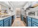 Galley kitchen featuring blue cabinets, stainless appliances, and walk-in pantry at 318 Tuxworth Cir, Decatur, GA 30033