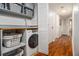 Efficient laundry room with washer/dryer, shelving, and ample storage space along the hallway at 318 Tuxworth Cir, Decatur, GA 30033