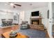 Cozy living room with fireplace, wood floors, and an open floor plan at 318 Tuxworth Cir, Decatur, GA 30033