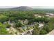 Aerial view of a residential neighborhood with tree-lined streets and view of Stone Mountain at 429 Orchard Dr, Stone Mountain, GA 30083