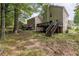 Backyard with a wooden deck, steps, and surrounded by mature trees; perfect for outdoor enjoyment at 429 Orchard Dr, Stone Mountain, GA 30083