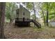 Backyard with wood deck, steps, and shaded by mature trees offering privacy and outdoor enjoyment at 429 Orchard Dr, Stone Mountain, GA 30083