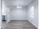 Open concept dining area features a modern chandelier and new laminate flooring at 429 Orchard Dr, Stone Mountain, GA 30083