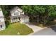 Charming two-story home featuring a quaint front porch, attached garage, and a lush, tree-filled yard enhancing curb appeal at 429 Orchard Dr, Stone Mountain, GA 30083