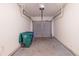 Attached single-car garage featuring a gray garage door, metal rails and concrete flooring at 429 Orchard Dr, Stone Mountain, GA 30083