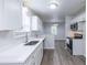 Bright kitchen with stainless steel appliances, white cabinets, and quartz countertops at 429 Orchard Dr, Stone Mountain, GA 30083