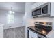 Updated kitchen features stainless steel appliances and an open view to the dining room at 429 Orchard Dr, Stone Mountain, GA 30083