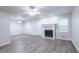 Spacious living room featuring new laminate flooring, a fireplace, and neutral paint at 429 Orchard Dr, Stone Mountain, GA 30083