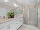 Bright bathroom with dual sinks, a glass-enclosed shower, and marble flooring at 964 Catamaran Ct, Alpharetta, GA 30005