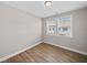 This cozy bedroom features attractive laminate floors and natural light from the double window at 964 Catamaran Ct, Alpharetta, GA 30005