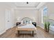 Inviting bedroom with a comfortable bed, bench, and tray ceiling at 964 Catamaran Ct, Alpharetta, GA 30005
