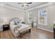 Bright bedroom with tray ceiling, hardwood floors, and large windows at 964 Catamaran Ct, Alpharetta, GA 30005