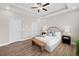 Spacious bedroom featuring a tray ceiling, neutral colors, and laminate flooring at 964 Catamaran Ct, Alpharetta, GA 30005