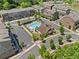 Overhead view of a community pool featuring lounge chairs, a clubhouse, and lush landscaping at 964 Catamaran Ct, Alpharetta, GA 30005