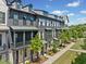 A row of townhomes with mixed exteriors and professional landscaping on a sunny day at 964 Catamaran Ct, Alpharetta, GA 30005