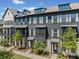 Modern townhome exterior showcasing gray siding, white trim, and well-manicured landscaping for curb appeal at 964 Catamaran Ct, Alpharetta, GA 30005