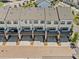 Rear view of modern townhomes with individual garages and covered decks, providing outdoor space at 964 Catamaran Ct, Alpharetta, GA 30005