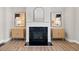 Modern fireplace with mantel, flanked by two side cabinets and decorative items, adding a cozy and stylish touch at 964 Catamaran Ct, Alpharetta, GA 30005