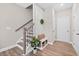 Inviting foyer area featuring a staircase, decorative bench, and ample storage with wood laminate flooring at 964 Catamaran Ct, Alpharetta, GA 30005