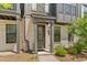 Charming front entrance with brick accents, covered entry, and well-maintained landscaping for a welcoming appeal at 964 Catamaran Ct, Alpharetta, GA 30005