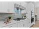 Modern kitchen with white cabinets, stainless steel appliances, and a stylish backsplash at 964 Catamaran Ct, Alpharetta, GA 30005