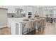 Elegant kitchen with a central island, seating, quartz countertops, stainless steel appliances, and modern backsplash at 964 Catamaran Ct, Alpharetta, GA 30005