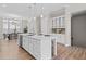 Bright, open-concept kitchen with stainless steel appliances, white cabinetry, hardwood floors, and large center island at 964 Catamaran Ct, Alpharetta, GA 30005