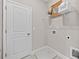 This laundry room includes wire shelving, a mirror, and a small drain at 964 Catamaran Ct, Alpharetta, GA 30005