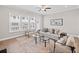 Inviting living room featuring large windows, hardwood floors, neutral color palette, and modern ceiling fan at 964 Catamaran Ct, Alpharetta, GA 30005