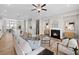 Open-concept living room with a fireplace, stylish furnishings, and seamless flow into the dining area at 964 Catamaran Ct, Alpharetta, GA 30005