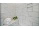 This shower features sleek white marble tiling, convenient built-in shelves, and a comfortable bench at 964 Catamaran Ct, Alpharetta, GA 30005