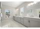 Bright bathroom with double vanity, marble floors, and modern fixtures at 2005 Haley Walk, Woodstock, GA 30188