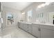 Bright bathroom with marble floors, double vanity, and large window offering natural light at 2005 Haley Walk, Woodstock, GA 30188