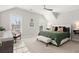 Bright bedroom with vaulted ceiling, two windows, ceiling fan, and neutral decor and furnishings at 2005 Haley Walk, Woodstock, GA 30188