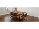 Dining room with modern industrial-style table, hardwood flooring, and a sunlit window at 2005 Haley Walk, Woodstock, GA 30188