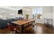 Dining area open to living room with industrial style table, chairs and a built-in bench at 2005 Haley Walk, Woodstock, GA 30188