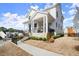 Angled view of a charming two-story home with a stone foundation and a cozy front porch at 2005 Haley Walk, Woodstock, GA 30188