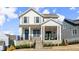 Charming two-story home with white siding, a stone foundation, and a welcoming front porch at 2005 Haley Walk, Woodstock, GA 30188
